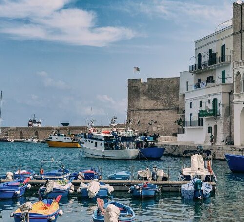 Blue boats in Monopoli's Old Port in Puglia.