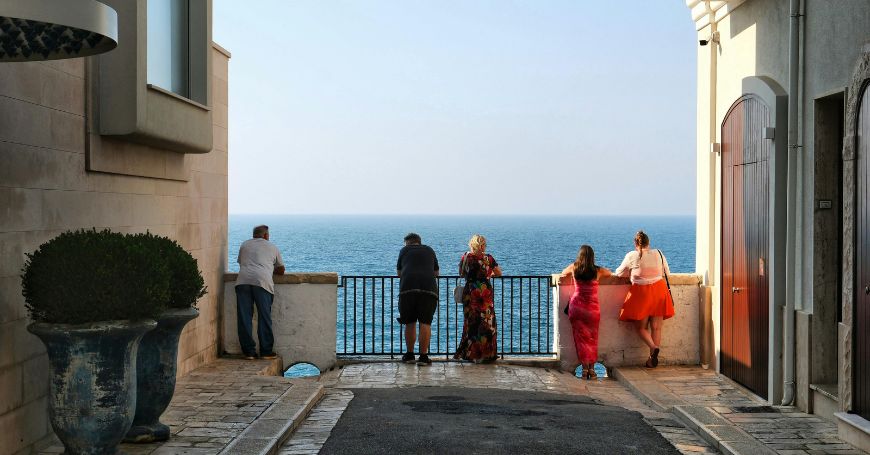 People enjoying the view on one of Polignano a Mare's famous balconate.