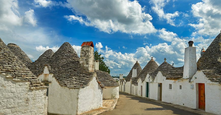 Traditional trulli houses lining a quiet street in the heart of valle d'itria
